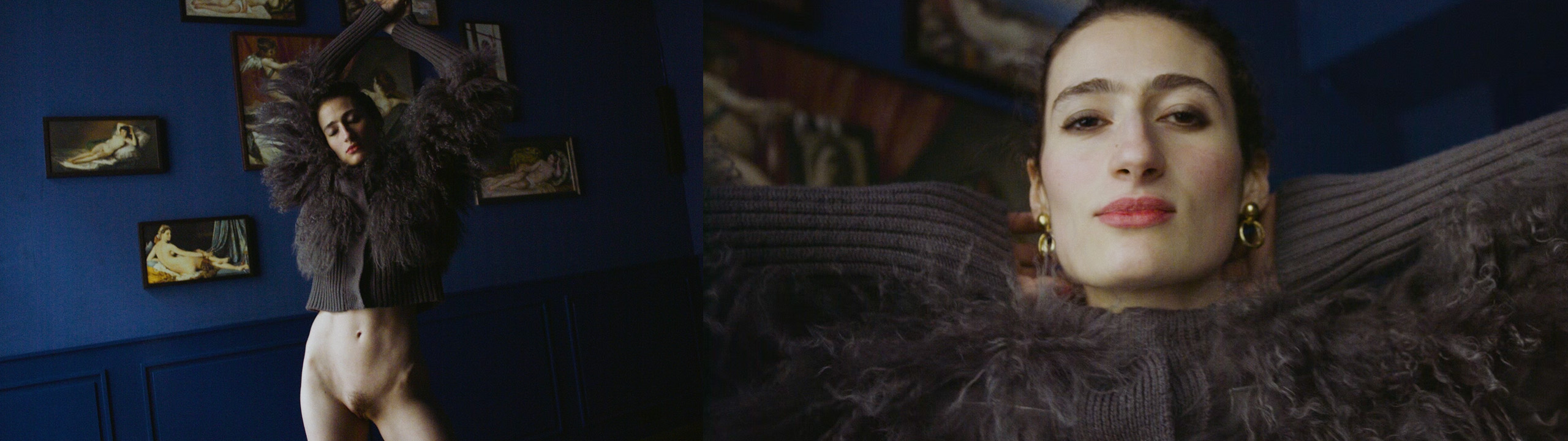 Left: Niki stands lost in her own world, eyes closed and arms stretched upward, in front of a blue wall adorned with small paintings of nude women. She wears red lipstick and nothing but a fluffy grey fur jacket. The skin of her lower abdomen and stomach appears velvety soft in the gentle light. Right: A close-up of Niki’s expressive face. Her arms are crossed behind her head, and with red lips and golden earrings, she looks boldly into the camera.